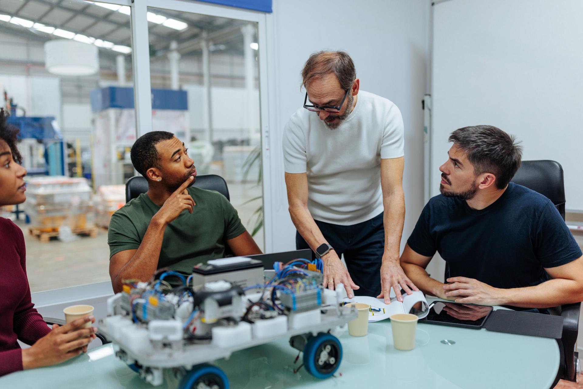 Engineers collaborating on robotics project in high-tech office